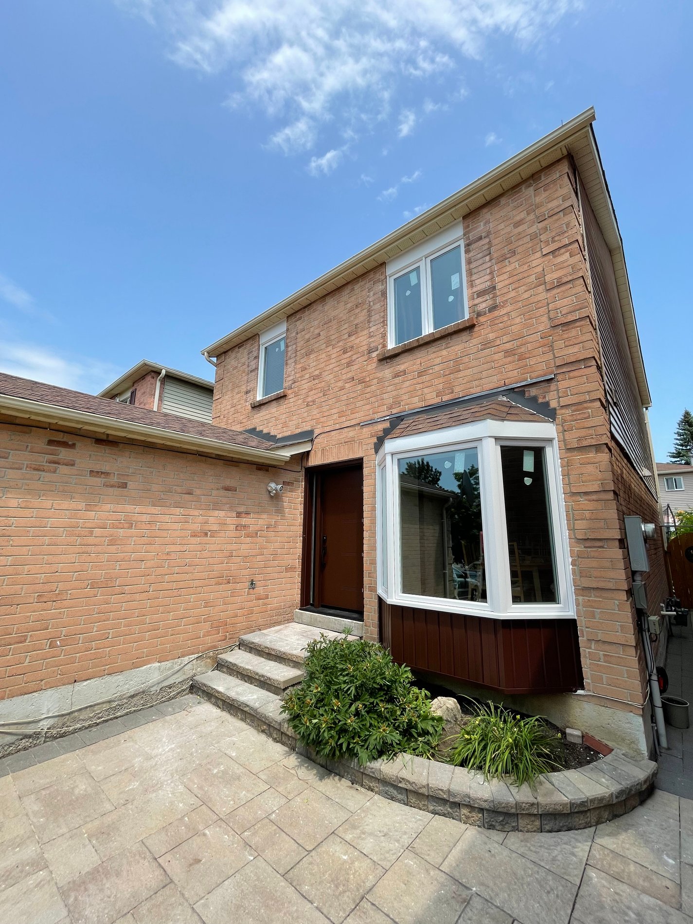 Brick house with landscaping and stone steps