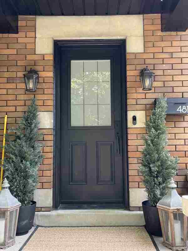 Black entry door with grid glass upper pane Black entry door with grid glass upper pane