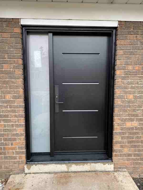 Black front door with frosted sidelight and metal inlays Black front door with frosted sidelight and metal inlays