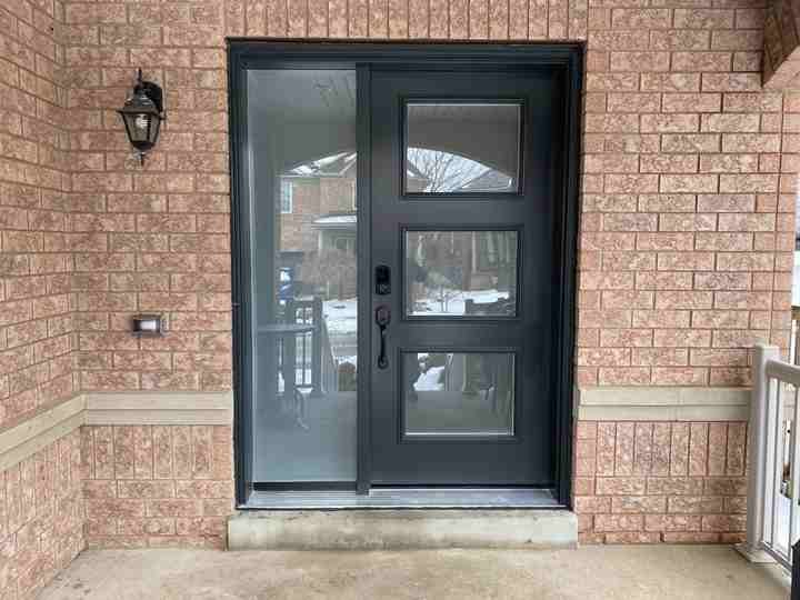 Entry door installation Ontario — black front door with sidelight by Window Experts Black entry door with horizontal glass lites and sidelight installed on an Ontario home