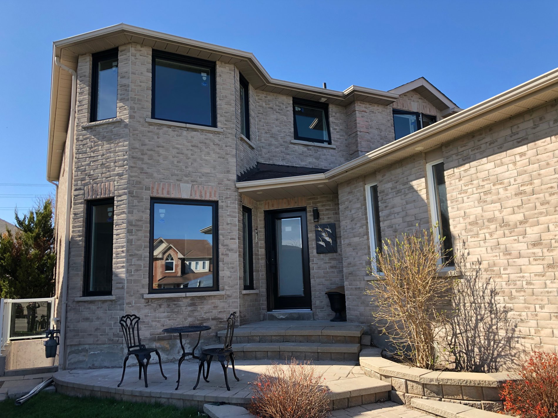 Modern home exterior with new windows and front steps