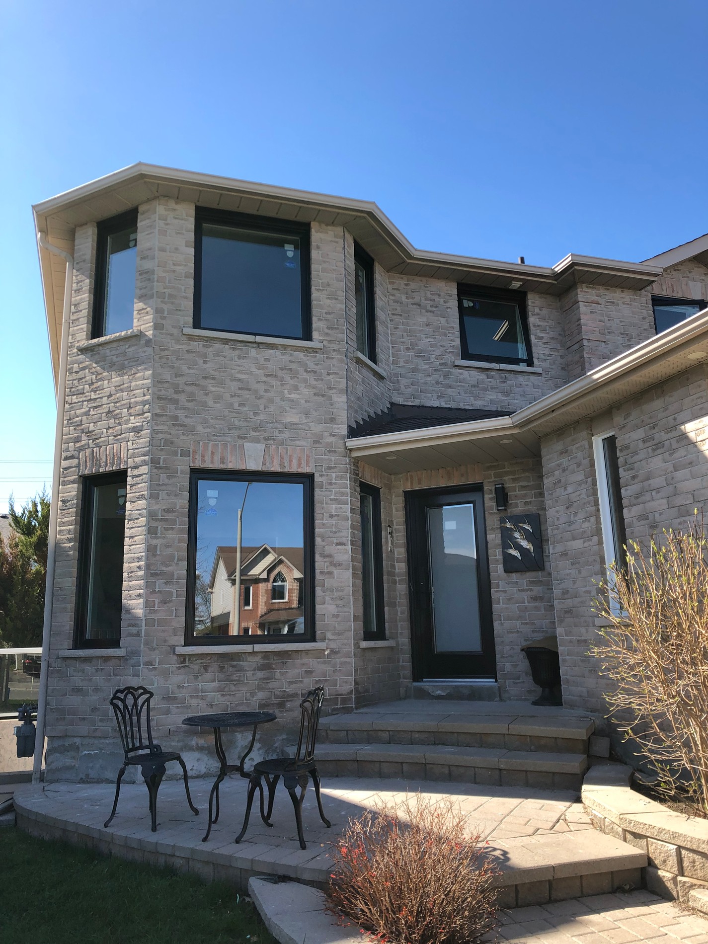 Modern home exterior with new windows and a covered porch