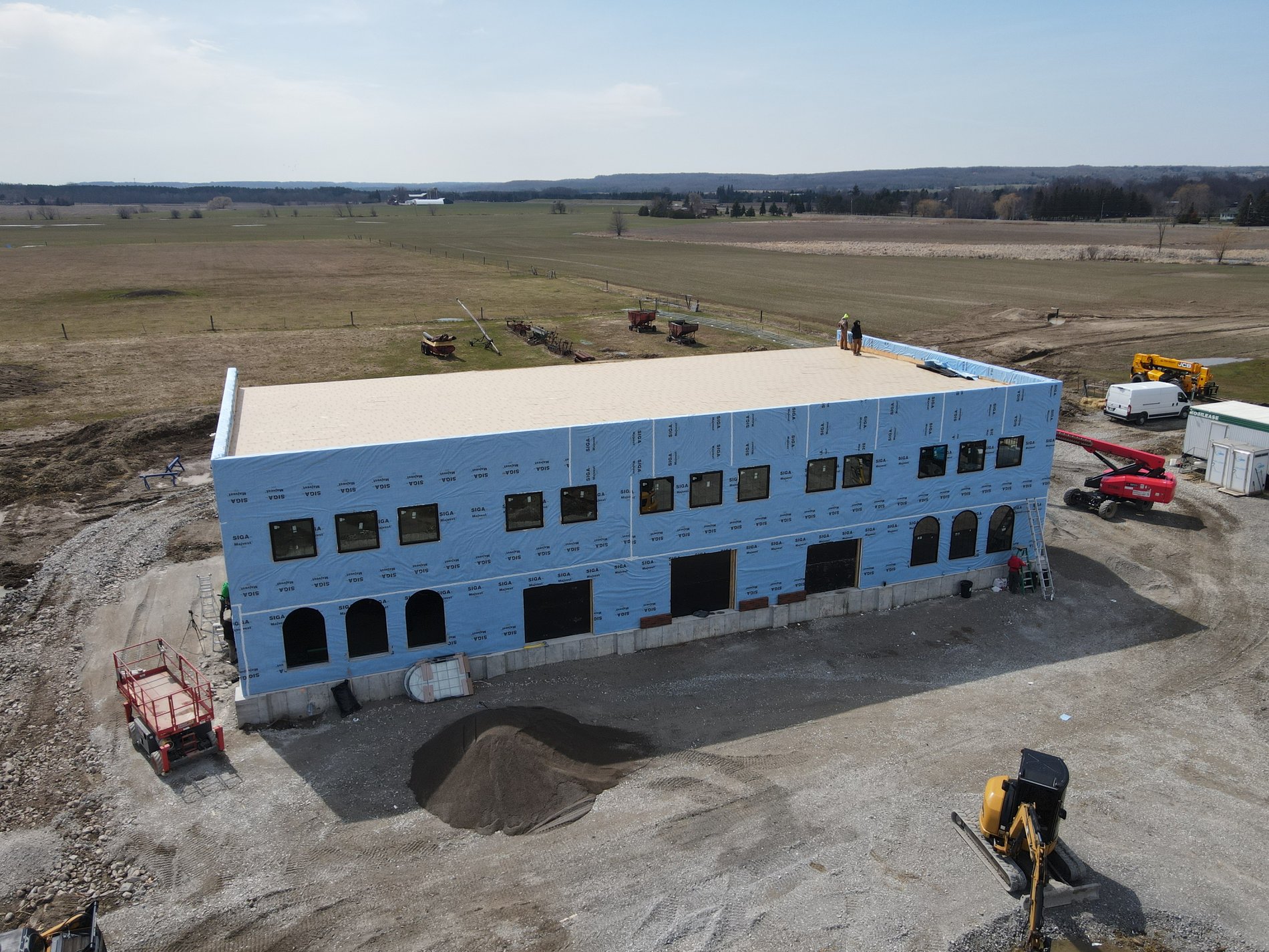 New building under construction with windows being installed