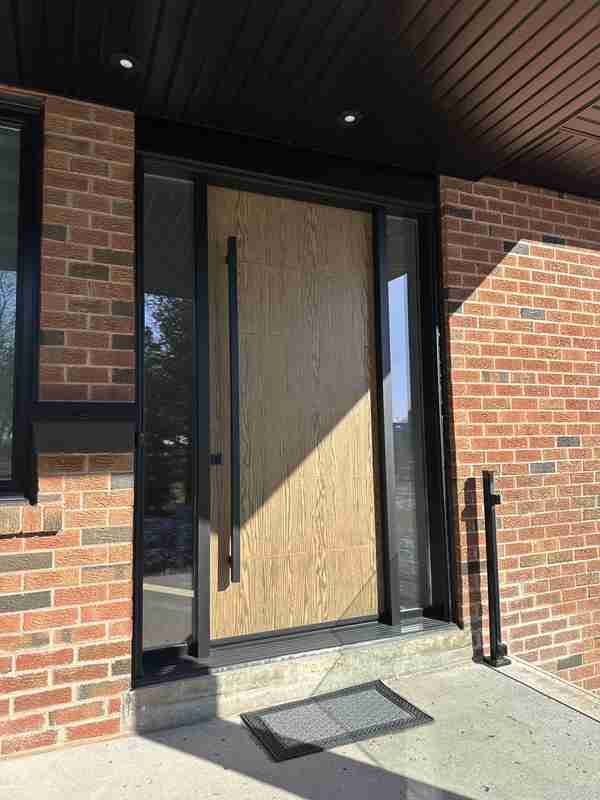 Oak wood-grain entry door with black sidelights Oak wood-grain entry door with black sidelights