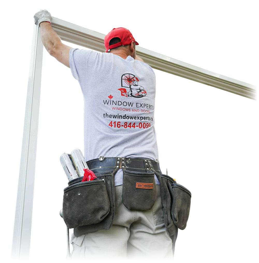 Worker in a Window Experts t-shirt and tool belt installing a window frame
