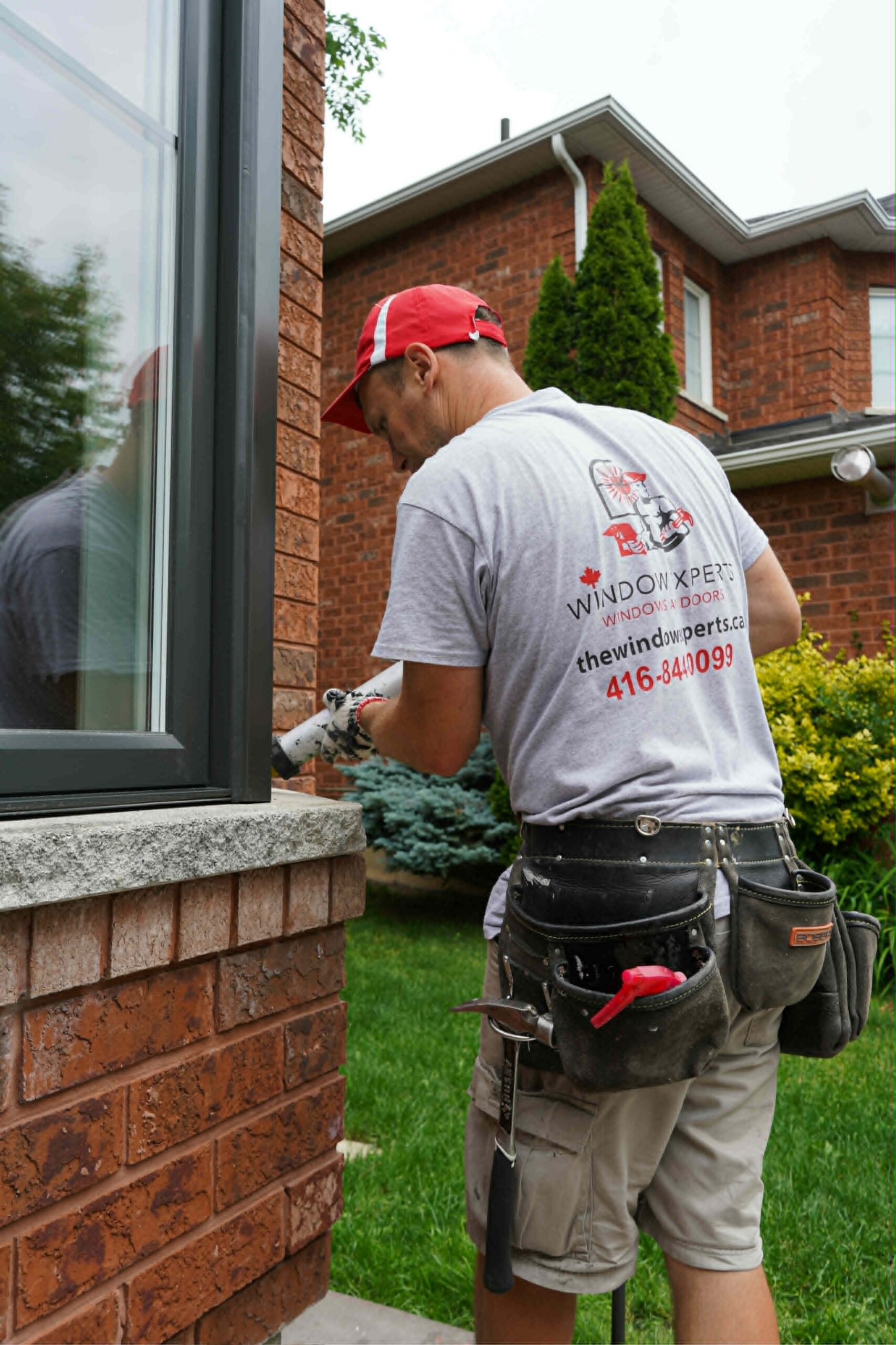 Window Experts installer working on a home exterior window