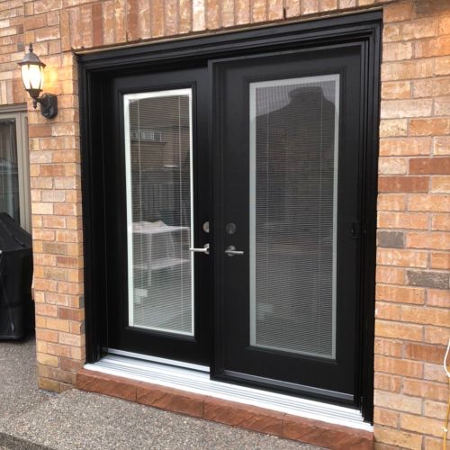 Black double doors on a modern home exterior